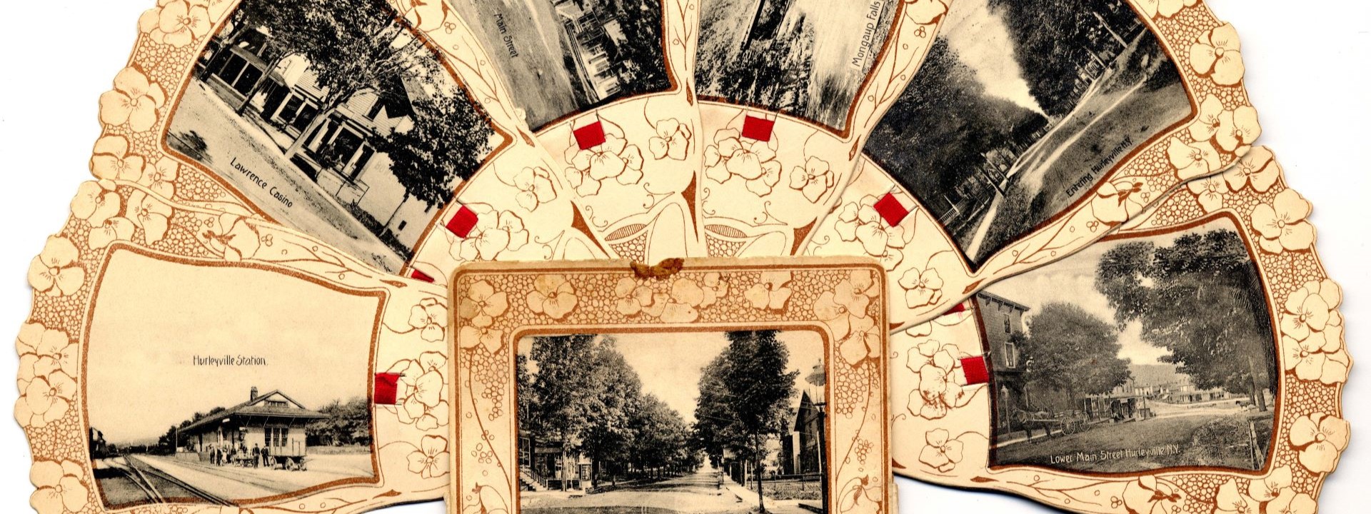 Novelty souvenir postcard album that folds out into the shape of a fan and features black and white photo postcards.