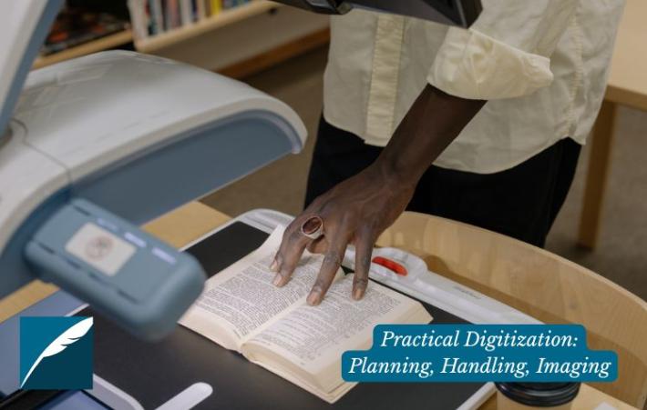 A person's hands working with documents under a scanner. 
